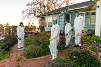 Winter Reign (center) and Brendan Armm (right) regroup with their children, River and Leaf, as they clean their Pacific Palisades home on April 6 after it sustained smoke and soot damage from the Los Angeles wildfires.
