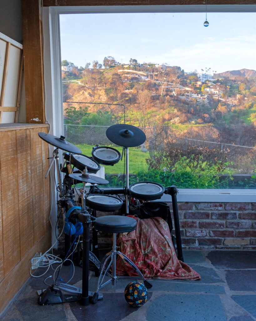 Leaf’s drum kit sits abandoned in the corner of the sunroom, overlooking the canyon.