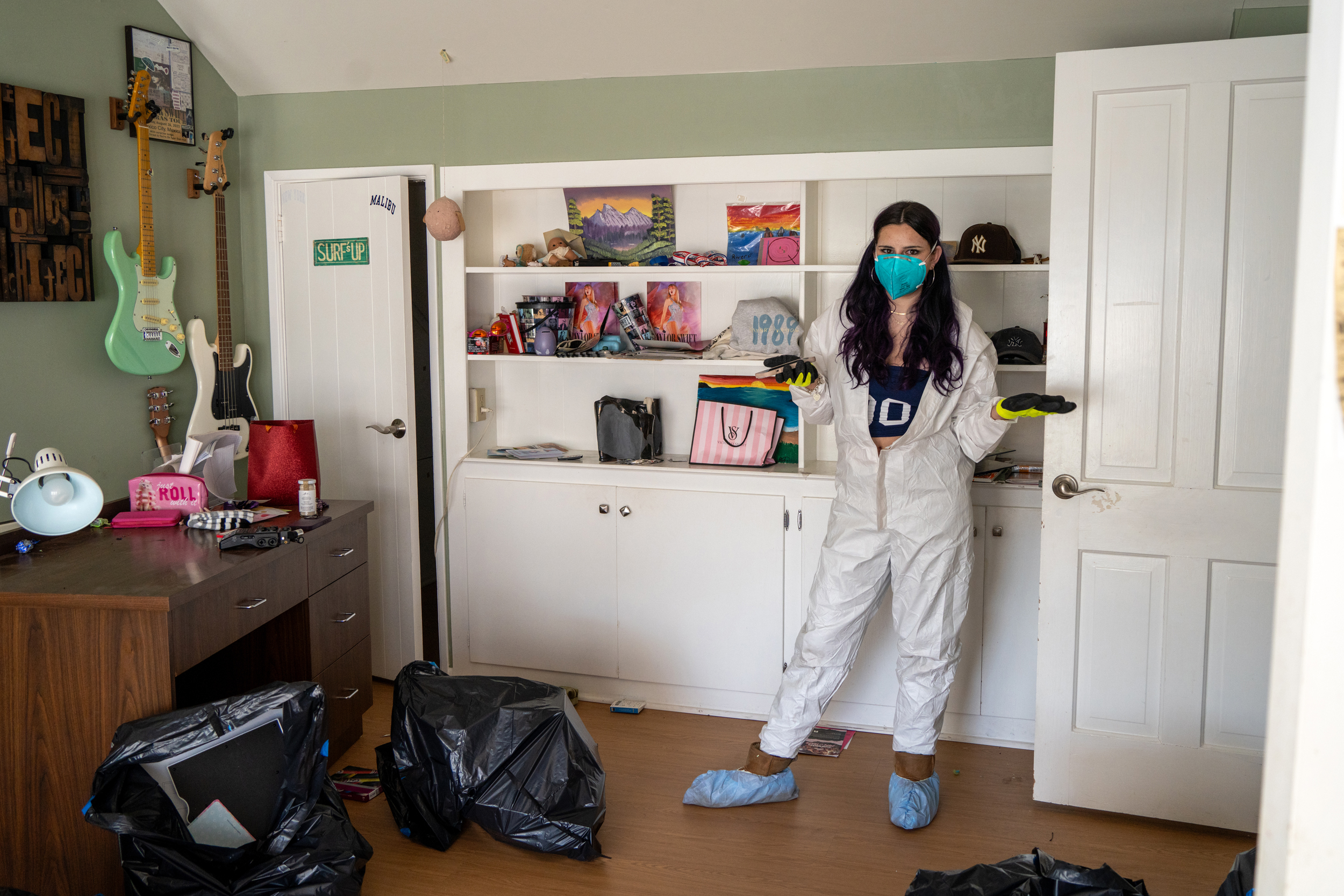 River stands in a corner of her room as she sorts through her belongings.