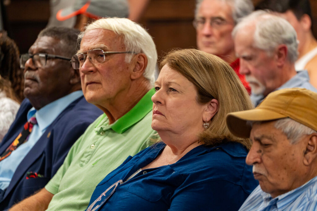 Residents Marshall Killingsworth and Becky Morgan listen to commissioners during the Tuesday meeting. Credit: Lee Hedgepeth/Inside Climate News