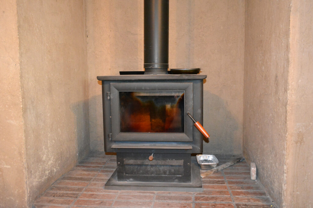 A new wood stove was installed in Carol Parrish’s home thanks to assistance from Red Feather. Credit: Wyatt Myskow/Inside Climate News