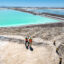 Visitors stand atop a large mound of salt byproduct from lithium production at a mine in the Atacama Desert of Chile. Credit: John Moore/Getty Images