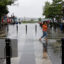 A woman walks through high tide floodwaters on Aug. 9, 2024, in Alexandria, Va. Credit: Anna Moneymaker/Getty Images