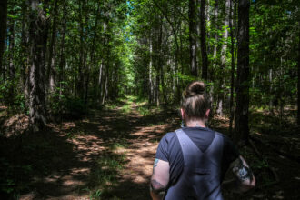 Allyson Gray, of the Pamunkey Indian Tribe, strolls the land called Dragon Run, swampy land that was inhabited by indigenous groups who fled persecution in the early days of American colonialism on Aug. 23, 2024, near Center Cross, Va. Credit: Jahi Chikwendiu/The Washington Post via Getty Images