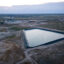 A fracking wastewater pond is seen in the Permian Basin near Odessa, Texas. Credit: Jon Shapley/Houston Chronicle via Getty Images