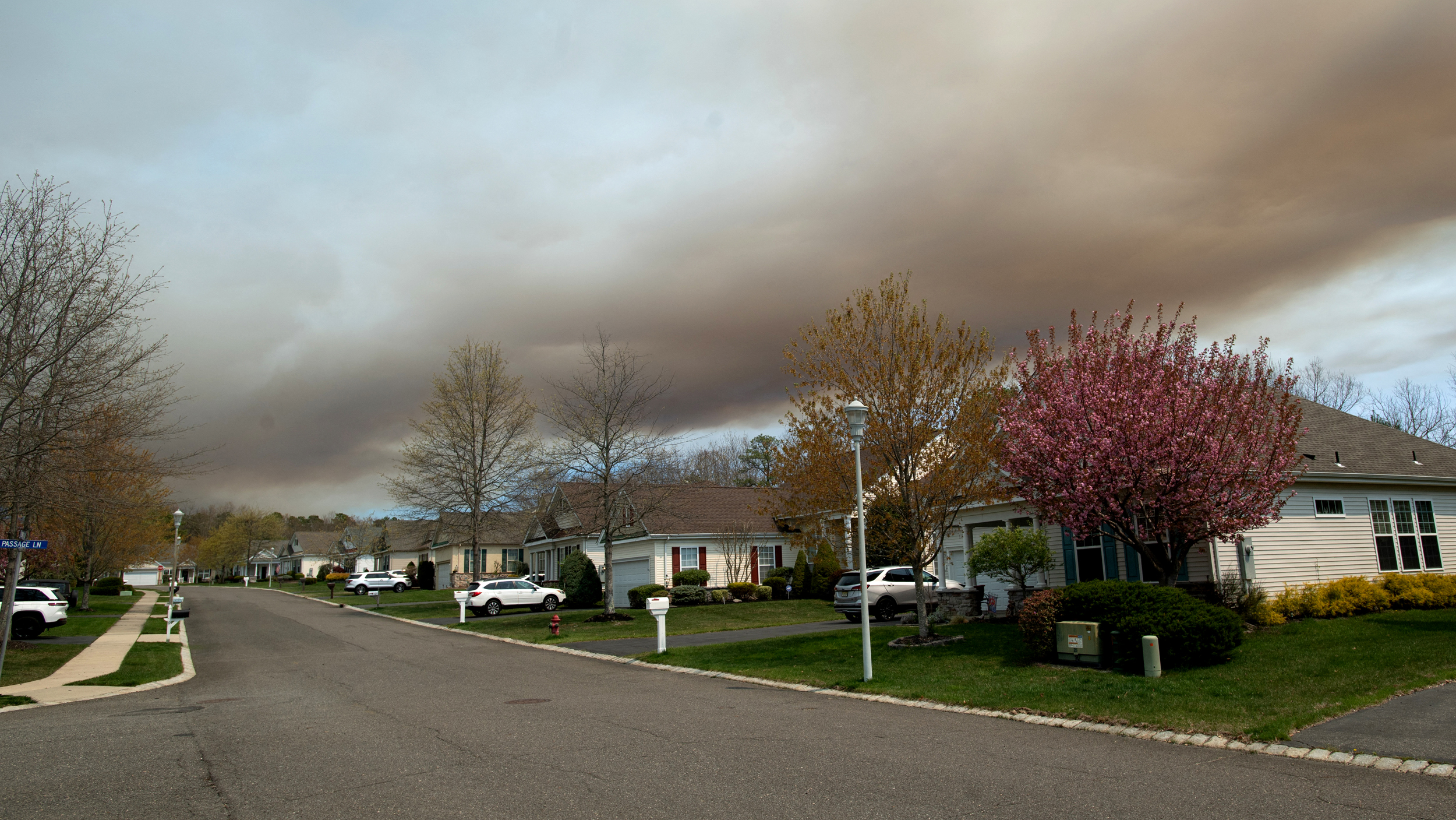 Smoke from the Jones Road fire is seen over homes on April 23 in Ocean County, N.J. Credit: Matthew Hatcher/AFP via Getty Images