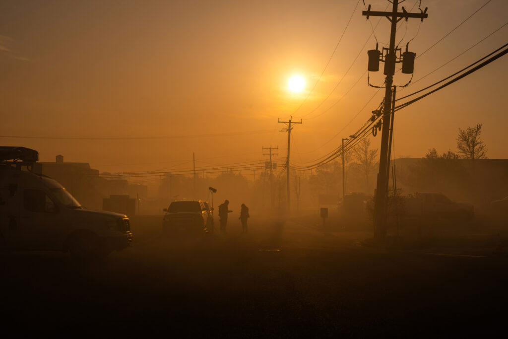 A street is shrouded in smoke from the Jones Road fire on April 24 in Forked River, N.J. Credit: Adam Gray/Getty Images