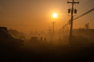 A television crew is shrouded in smoke from the Jones Road fire on April 24 in Forked River, N.J. Credit: Adam Gray/Getty Images