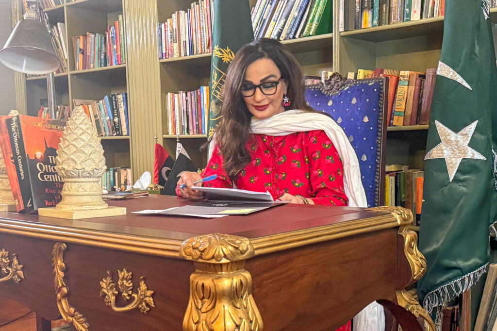 Sherry Rehman, Pakistan’s former climate change minister and a sitting senator, flips through official files in her home office, nestled in Karachi’s upscale Defense neighborhood. Credit: Aman Azhar/Inside Climate News