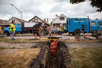A construction crew completes a lead service line replacement at a Chicago home in June 2023. Credit: Vanessa Bly/NRDC