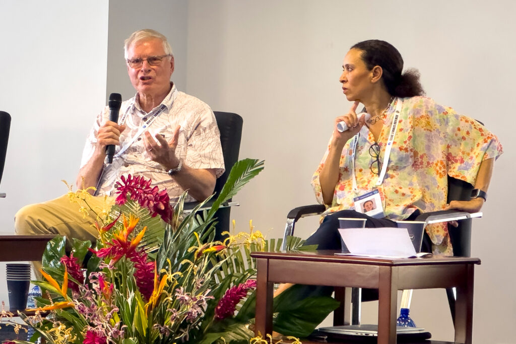 Johann Bell, left, and Tarub Bahri discuss the impacts of climate change on tuna stocks during a side event at the Honiara Summit in February. Credit: Nathan Eagle/Civil Beat