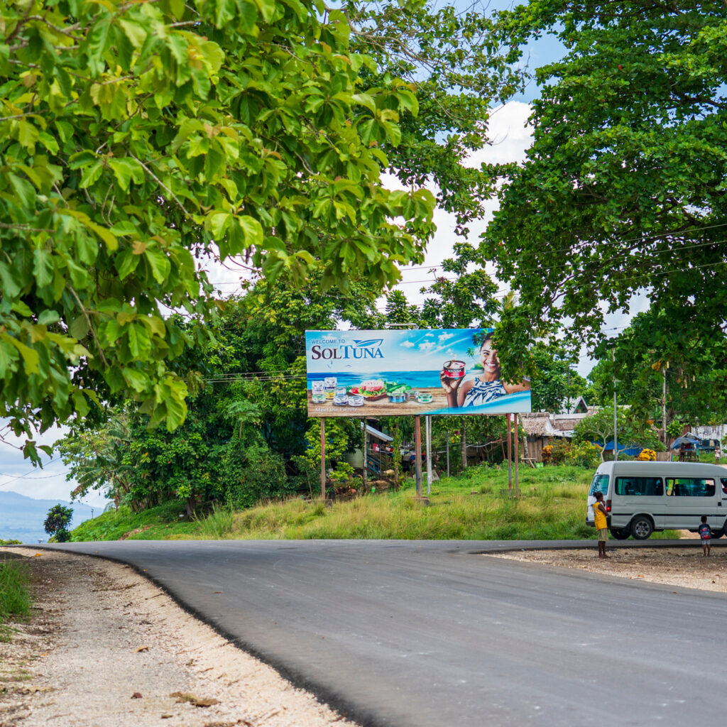 A sign advertises SolTuna canned tuna in Noro just up the road from the cannery. Credit: Nathan Eagle/Civil Beat