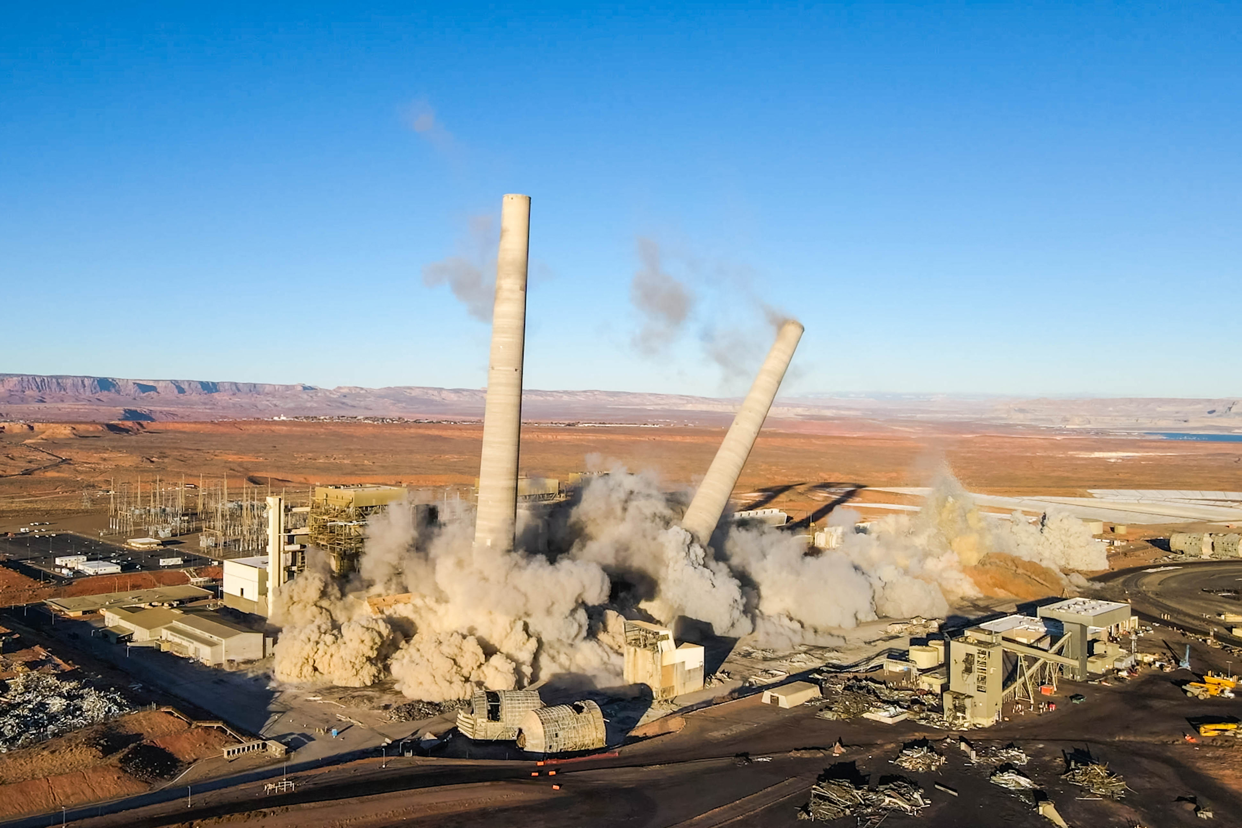 The three smokestacks of the Navajo Generating Station were demolished in December 2020. Credit: EcoFlight
