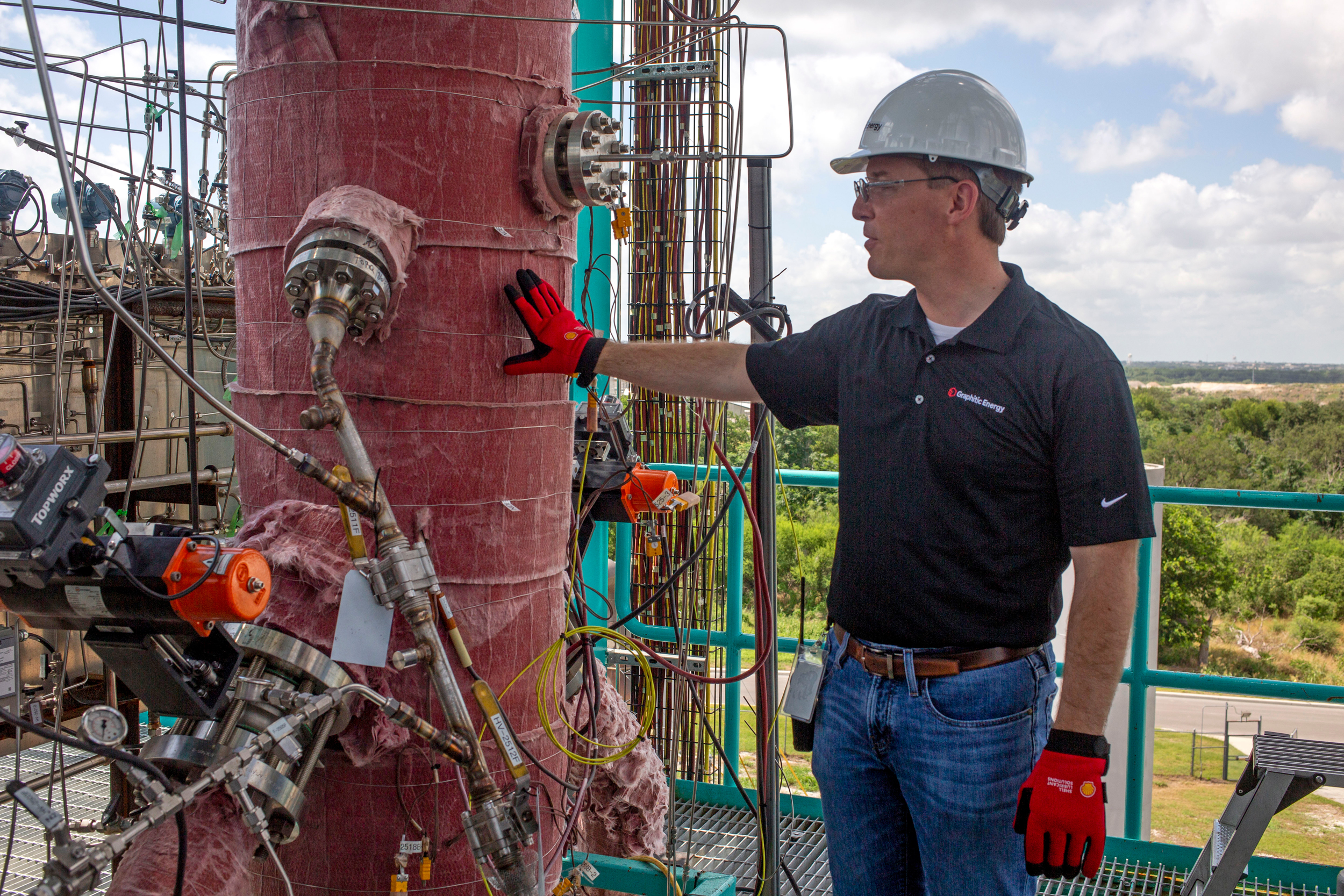 Patrick Hanks, chief technology officer of Graphitic Energy, talks about the carbon formation vessel on the company’s San Antonio pilot project, which pulls solid carbon graphite out of methane gas. Credit: Dylan Baddour/Inside Climate News