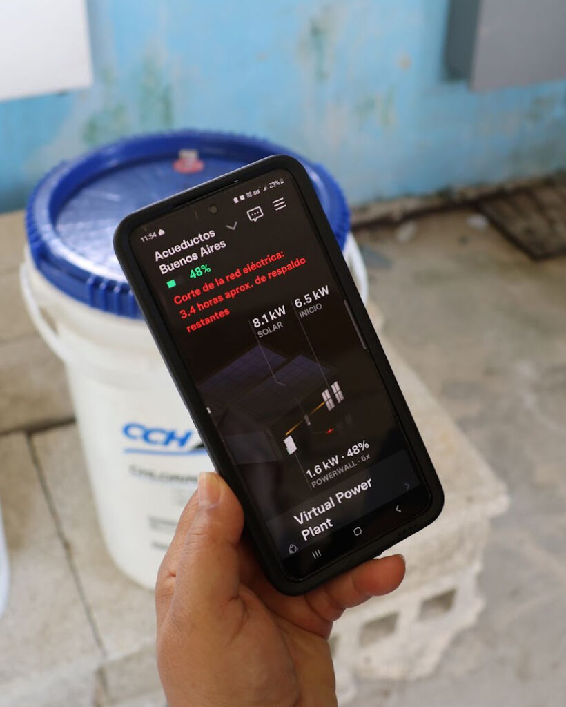 Eva Rodriguez checks the functionality of the solar panels via an app on her phone. She is able to keep track of the amount of energy the solar panels have and are using, as well as their functionality. Credit: Sarah Mattalian