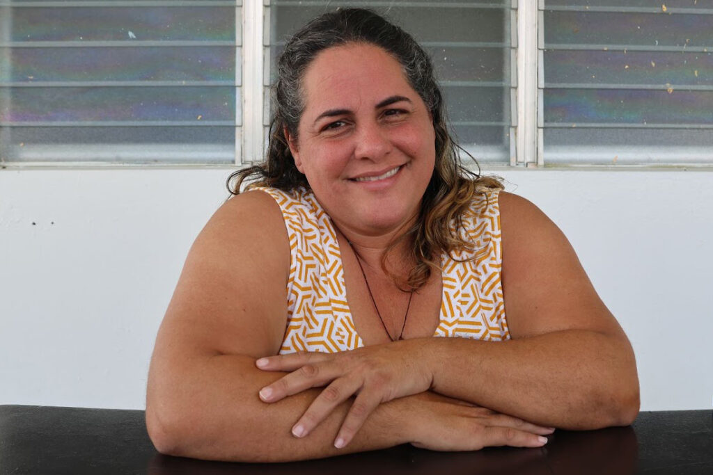 Miriam Matos Díaz posing for a photograph on her front porch on April 10 in Caguas, Puerto Rico. Credit: Sarah Mattalian