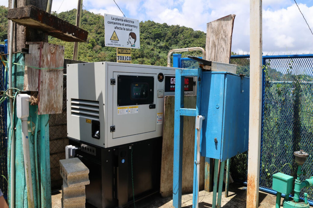 A generator is located next to the well. The system is located away from any residential houses and buildings because of the smell and noise of the generator. Credit: Sarah Mattalian