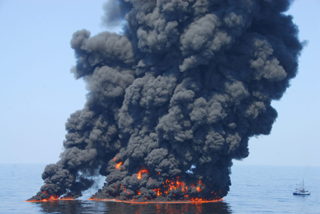 Response crews attempt a controlled burn of oil from BP’s Deepwater Horizon spill off the Louisiana coast in 2010. Credit: John Masson/U.S. Coast Guard