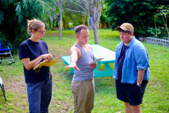 Klie Kliebert (right) works with the Imagine Water Works team on plans for the climate justice nonprofit’s sanctuary farm in New Orleans’ Seventh Ward. Credit: Audrey Gray/Inside Climate News