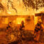 Firefighters battle against a burning apartment complex in Paradise as a late-season wildfire in northern California burns 20,000 acres on Nov. 9, 2018. Credit: Josh Edelson/AFP via Getty Images