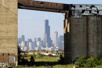 The Chicago skyline is seen through the Damen Silos. Credit: Raymond Boyd/Michael Ochs Archives/Getty Images