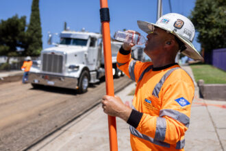 A road worker drinks water at a construction site in Los Angeles as southern California faces a heatwave on Sept. 4, 2024. Credit: Etienne Laurent/AFP via Getty Images