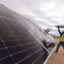 Workers install solar panels for the Los Angeles Department of Water and Power’s Eland Solar and Storage Center in the Mojave Desert of Kern County on Nov. 25, 2024. Credit: Brian van der Brug/Los Angeles Times via Getty Images
