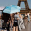 People hold umbrellas to protect themselves from the sun during a heatwave in Paris on June 30. Credit: Ludovic Marin/AFP via Getty Images