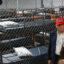 President Donald Trump speaks with Homeland Security Secretary Kristi Noem as they tour a migrant detention center, dubbed “Alligator Alcatraz,” located within Florida’s Big Cypress National Preserve. Credit: Andrew Caballero-Reynolds/AFP via Getty Images