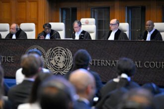 Yuji Iwasawa (center), president of the International Court of Justice, issues the first advisory opinion on States’ legal obligations to address climate change in The Hague on Wednesday. Credit: John Thys/AFP via Getty Images