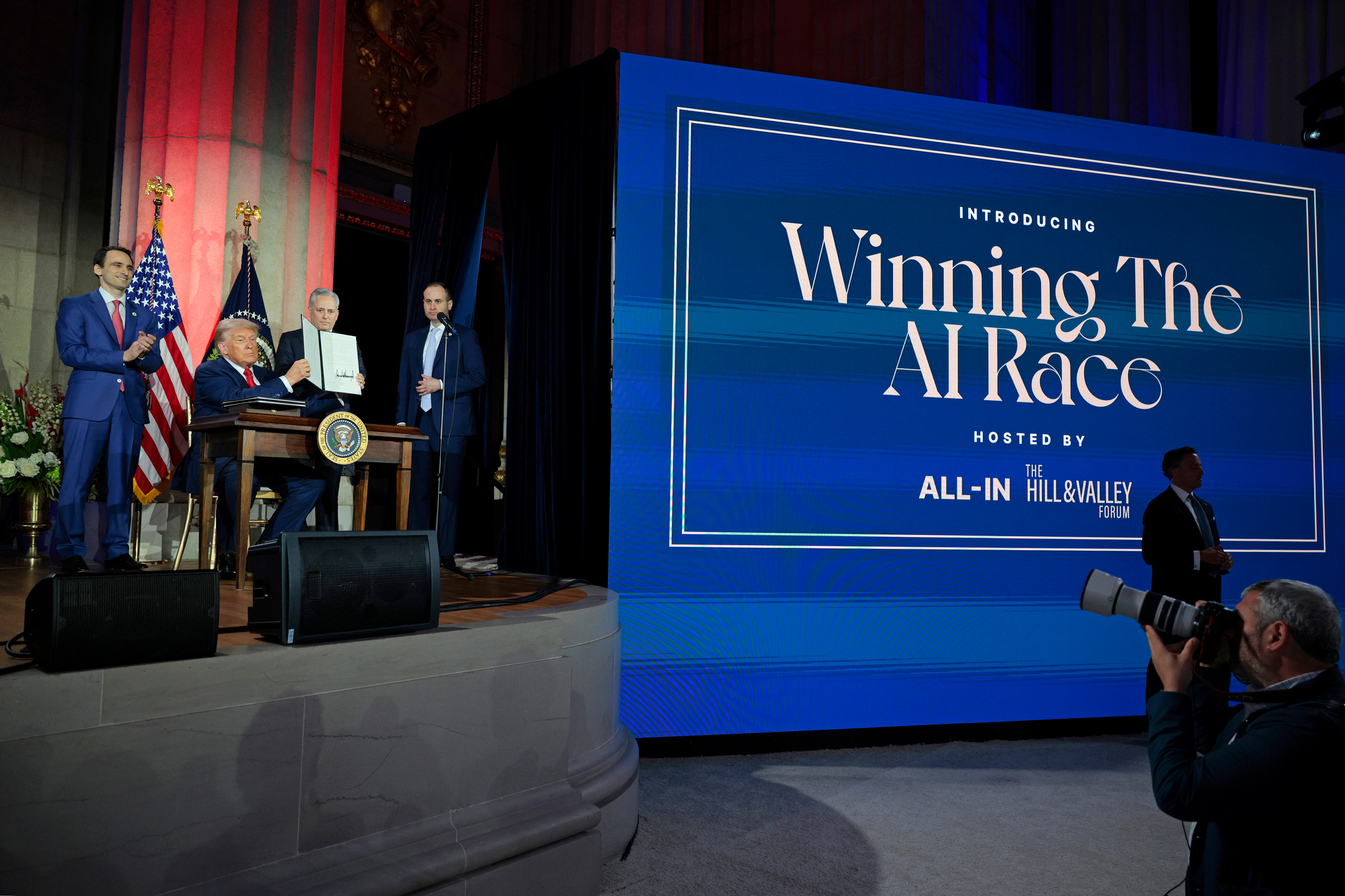 President Donald Trump displays a signed executive order during the “Winning the AI Race” summit at the Andrew W. Mellon Auditorium on Wednesday in Washington, D.C. Credit: Chip Somodevilla/Getty Images