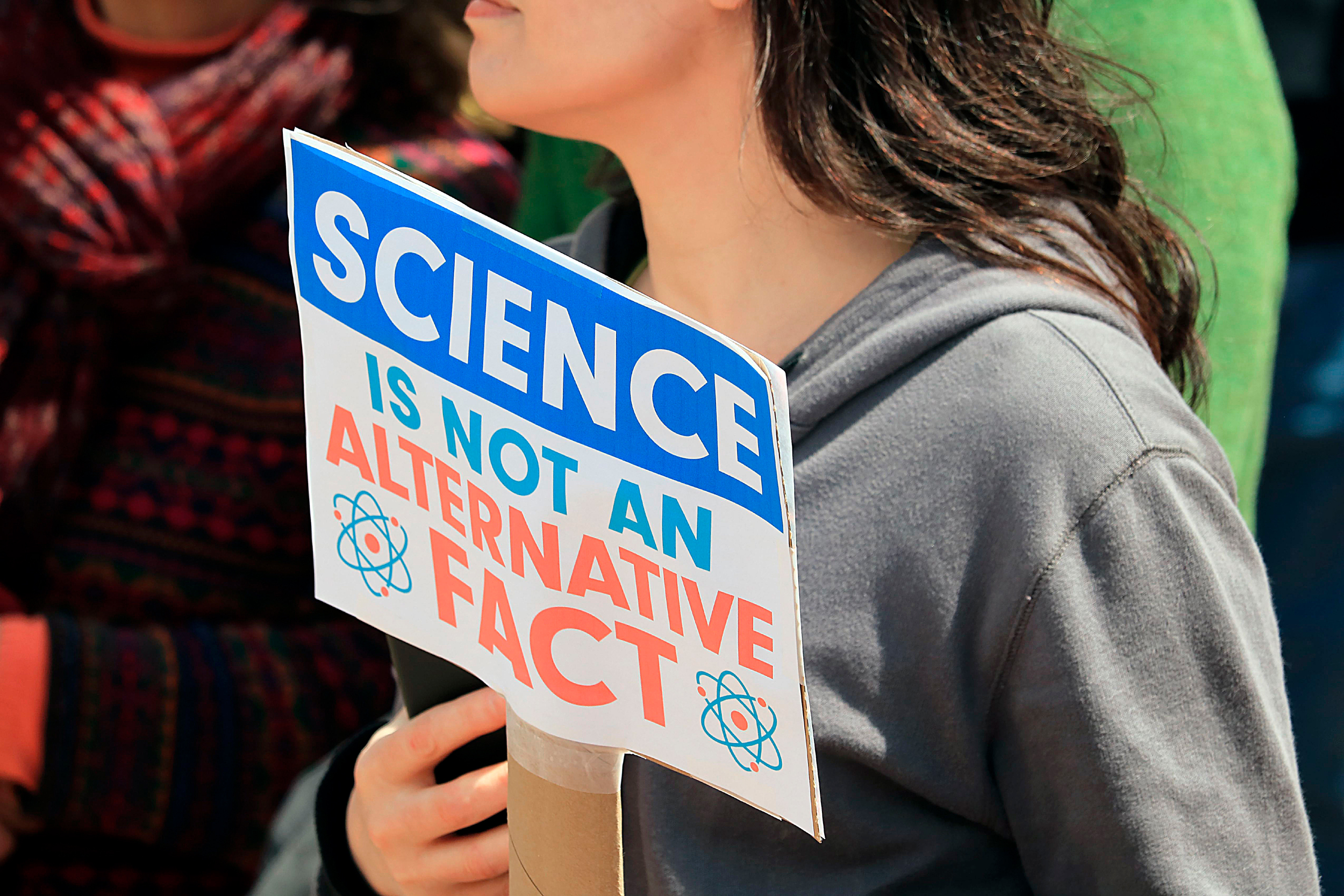 A woman holds a sign saying "Science in not an alternative fact" at the 2017 March for Science rally in Lafayette, Ind. Credit: Education Images/Universal Images Group via Getty Images