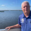 Okeechobee Mayor Dowling Watford stands in front of Florida’s Lake Okeechobee in May. Credit: Amy Green/Inside Climate News