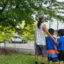 Geoffrey Ross and his two children, ages 5 and 6, stare ahead at the city of Niagara Falls, Ontario, outside a coffee shop on June 5. Wildfires in Manitoba forced them to evacuate. Credit: Angeles Ponpa/Medill News Service