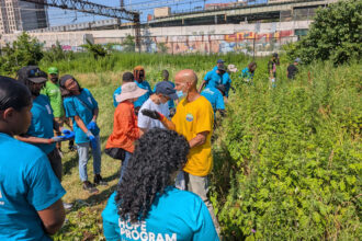 Rodney Santiago, a compost educator coordinator, leads a team of HOPE members through Concrete Plant Park in the South Bronx. Credit: HOPE