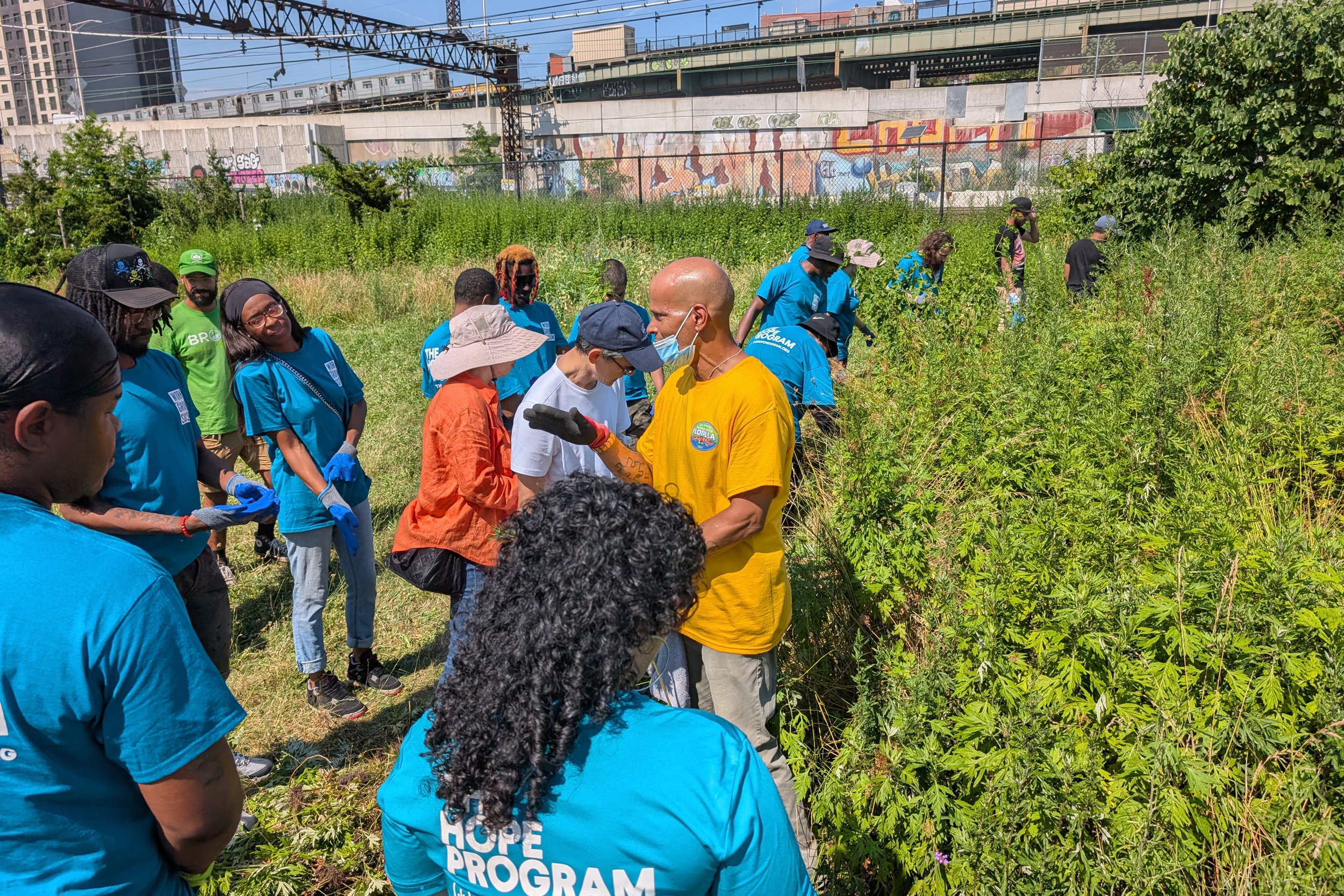 Rodney Santiago, a compost educator coordinator, leads a team of HOPE members through Concrete Plant Park in the South Bronx. Credit: HOPE