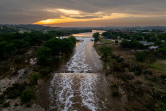 In Kerrville, Texas, the sun sets over the Guadalupe River on July 6. Heavy rainfall caused severe flooding along the Guadalupe River in central Texas, leaving more than 120 people reported dead. Credit: Brandon Bell/Getty Images.