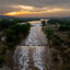 In Kerrville, Texas, the sun sets over the Guadalupe River on July 6. Heavy rainfall caused severe flooding along the Guadalupe River in central Texas, leaving more than 120 people reported dead. Credit: Brandon Bell/Getty Images.