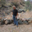 John Nordstrom stands before a rock dam he built on his property in Patagonia, Ariz., on July 9. Rock dams slows the speed of water, allowing it to better recharge the aquifer underground. Credit: Wyatt Myskow/Inside Climate News
