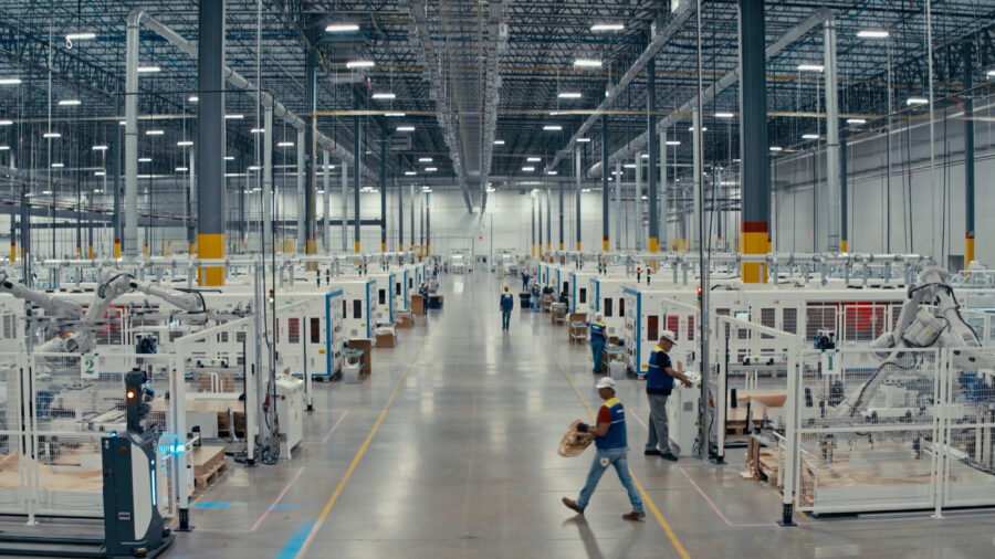 Employees walk the floor and supervise machines at the T1 Energy plant near Dallas. Credit: T1 Energy