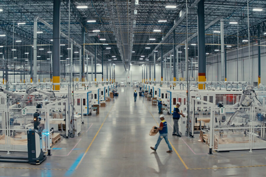 Employees walk the floor and supervise machines at the T1 Energy plant near Dallas. Credit: T1 Energy