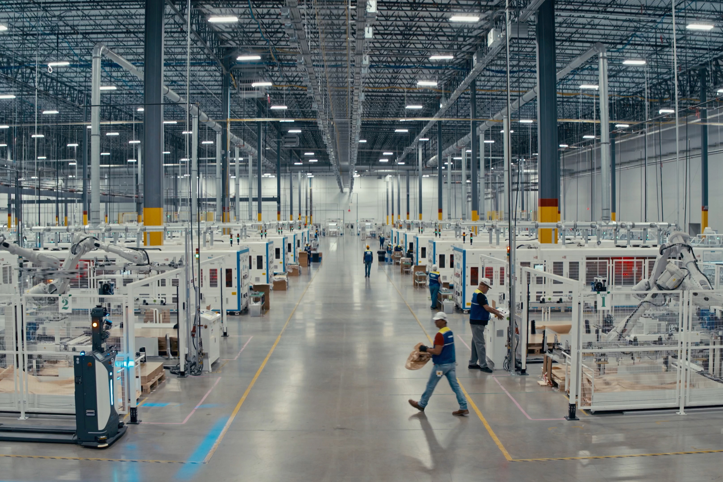 Employees walk the floor and supervise machines at the T1 Energy plant near Dallas. Credit: T1 Energy