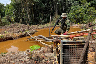 An officer of the Brazilian Institute of Environment and Renewable Natural Resources takes part in an operation against Amazon deforestation at an illegal mining camp known in the Yanomami of Brazil on Feb. 24, 2023. Credit: Alan Chaves/AFP via Getty Images