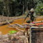 An officer of the Brazilian Institute of Environment and Renewable Natural Resources takes part in an operation against Amazon deforestation at an illegal mining camp known in the Yanomami of Brazil on Feb. 24, 2023. Credit: Alan Chaves/AFP via Getty Images