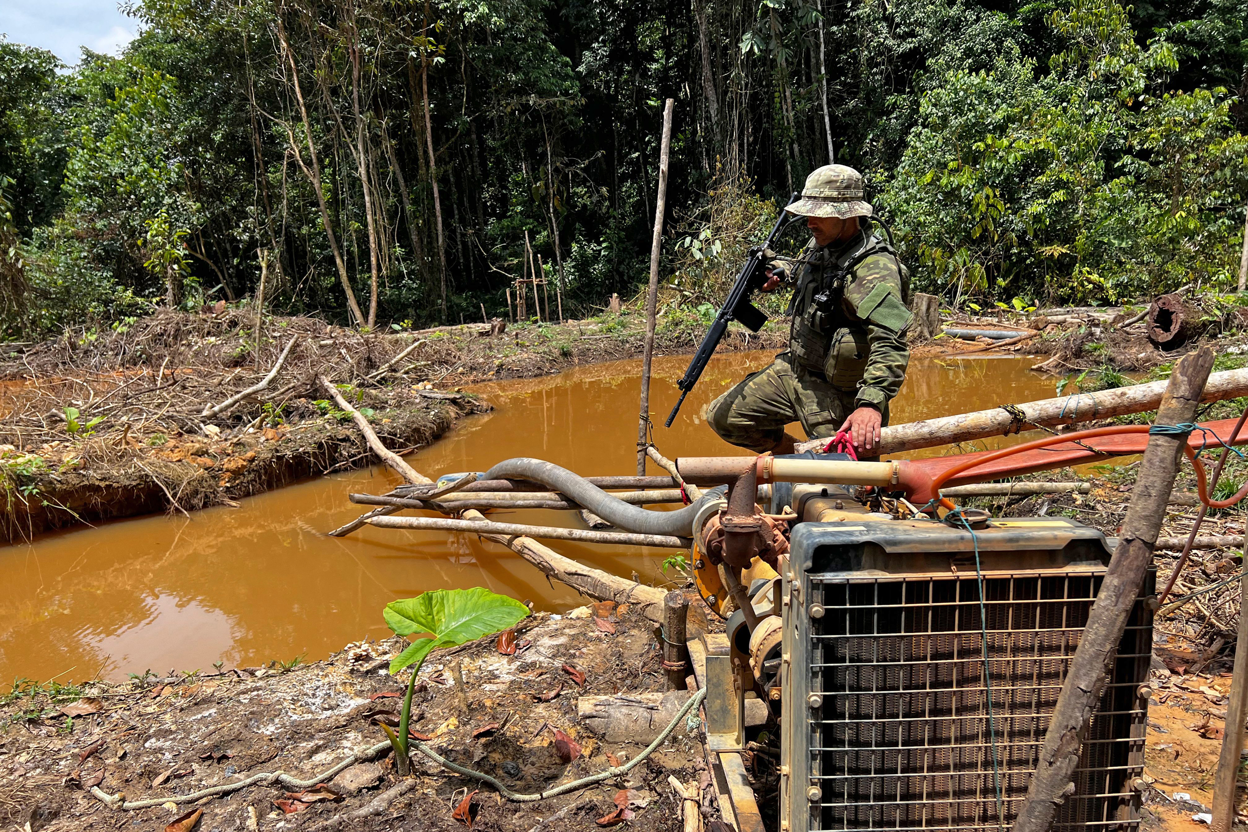 An officer of the Brazilian Institute of Environment and Renewable Natural Resources takes part in an operation against Amazon deforestation at an illegal mining camp known in the Yanomami of Brazil on Feb. 24, 2023. Credit: Alan Chaves/AFP via Getty Images