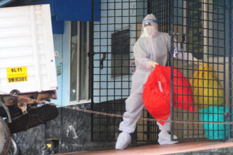 A health worker wears protective gear as they dispose of biohazard waste from a Nipah virus isolation center at a government hospital in India’s southern state of Kerala on Sept. 16, 2023. Credit: AFP via Getty Images