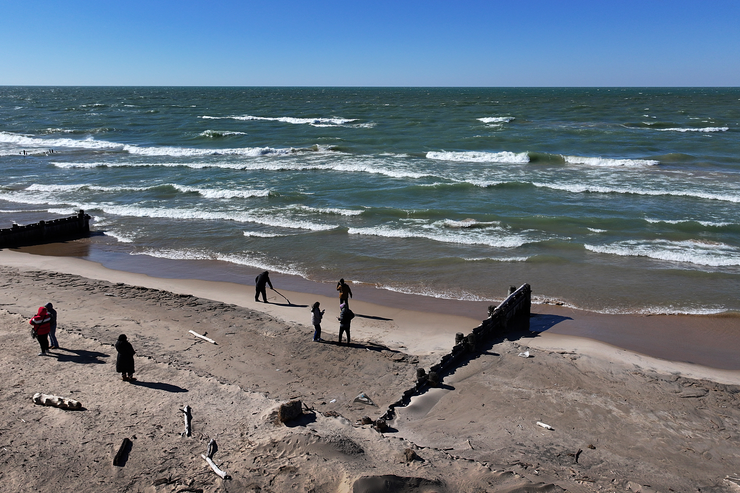 People walk a beach along Lake Michigan in Whiting, Ind. Credit: Scott Olson/Getty Images
