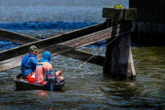 Two men fish in a small boat on a tributary of the Chesapeake Bay in Chester, Md., on May 30, 2024. Credit: Jim Watson/AFP via Getty Images