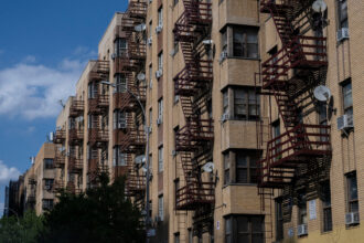 Air conditioning units hang out the windows of a housing project during a summer heat wave in the Bronx borough of New York on July 11, 2024. Credit: Angela Weiss/AFP via Getty Images
