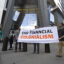 Reb Spring (left), the spokesperson for Debt for Climate, joins activists from Planet Over Profit to protest outside Wells Fargo’s corporate offices in New York City on July 23. Credit: Mostafa Bassim/Anadolu via Getty Images